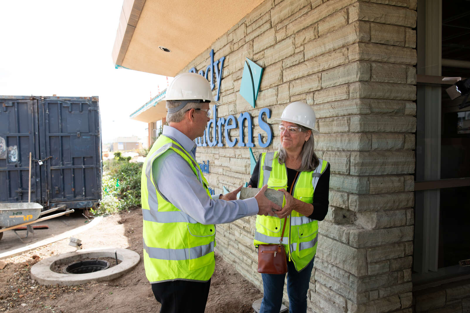 Rady Children’s Hospital-San Diego President and CEO Patrick Frias is pictured with Roxanne Ewalt removing a brick from the original 1954 Rady building that was about to be demolished.