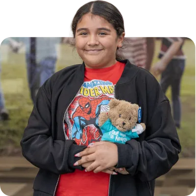 little girl holding rady children's teddy bear