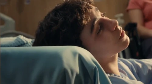 boy looking out towards window