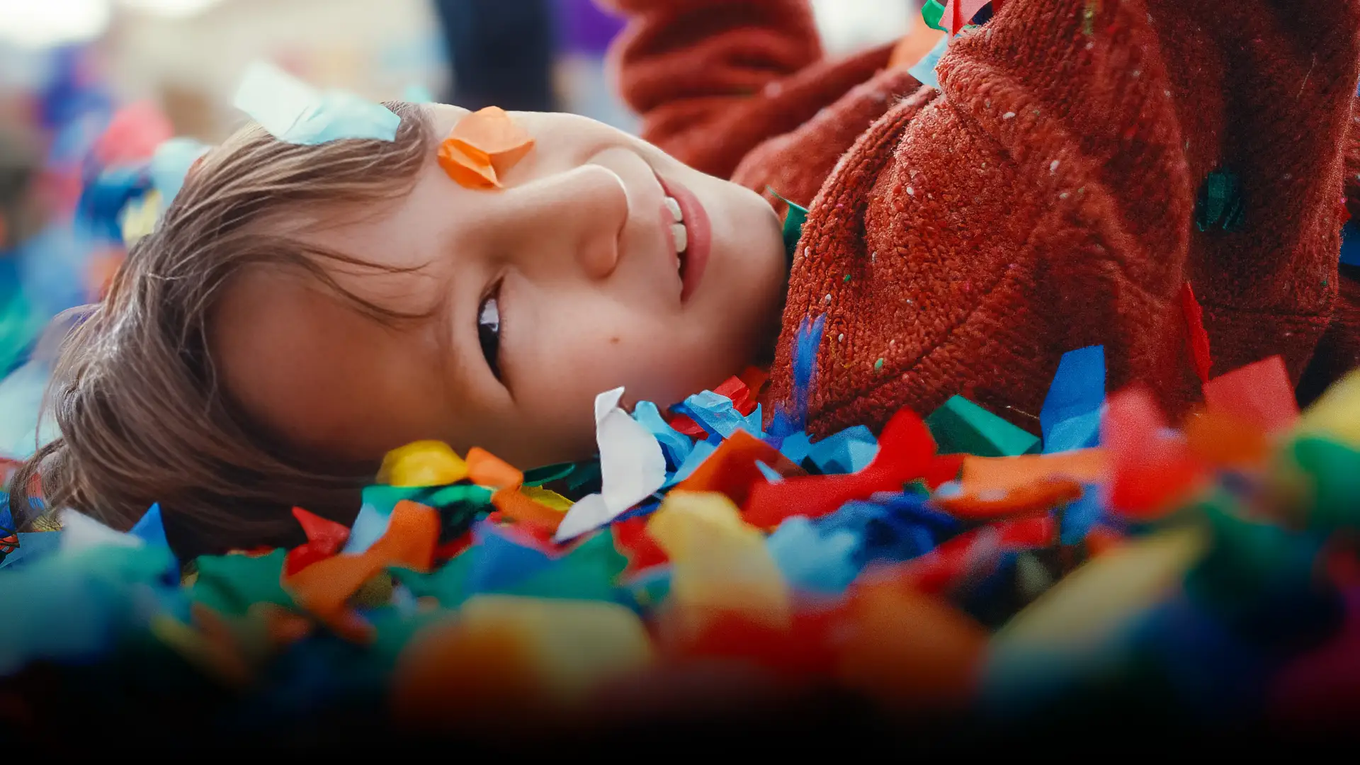 boy laying on confetti