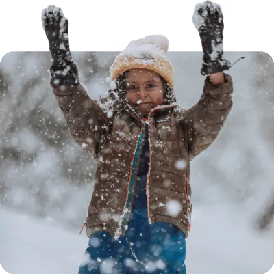 child playing in the snow